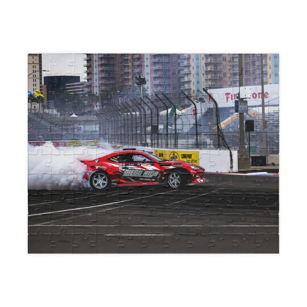 Red race car on a track with a cityscape background Diego Higa red drift car puzzle featuring a smoky racetrack drifting scene
